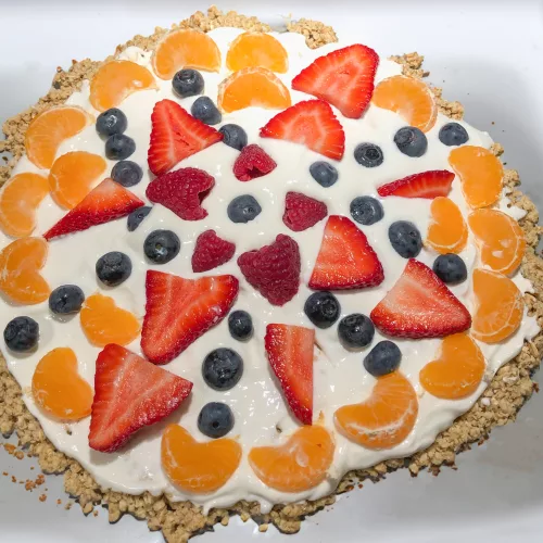 A healthy fruit pizza recipe made with greek yogurt, fruit and nuts.