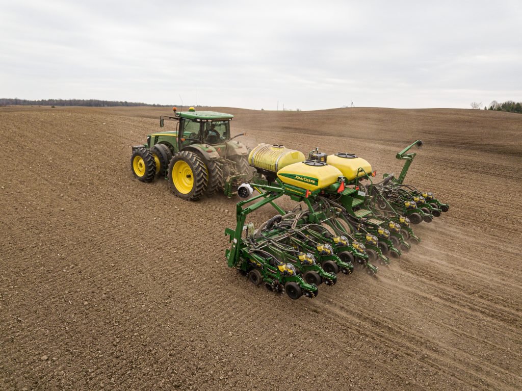 A tractor and planter using GPS technology in a field.